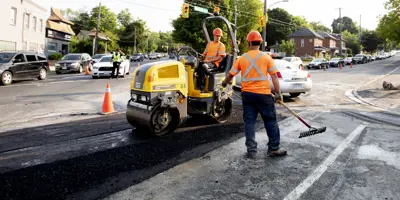 Road construction crew with two workers